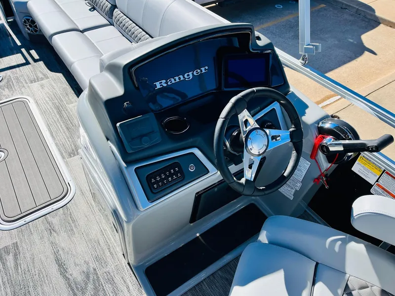Slide: The Image of 2025 Ranger Reata 223C boat dashboard with steering wheel and controls. - 28