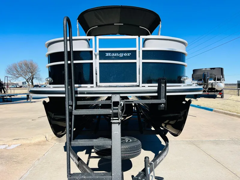 Slide: The Image of 2025 Ranger Reata 223C pontoon boat on trailer, viewed from the front. - 3