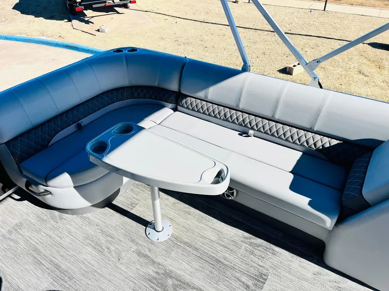 Slide: The Image of 2025 Ranger Reata 223C boat interior with gray seating and table. - 34
