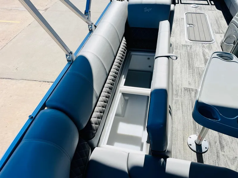 Slide: The Image of 2025 Ranger Reata 223C boat interior with open storage compartment and seating. - 35