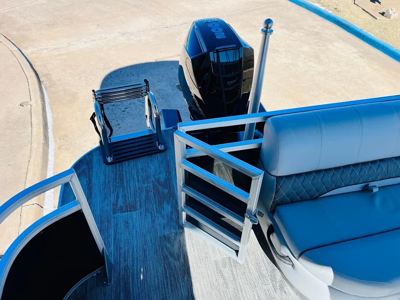 Slide: The Image of 2025 Ranger Reata 223C boat with seating and motor, viewed from above. - 37