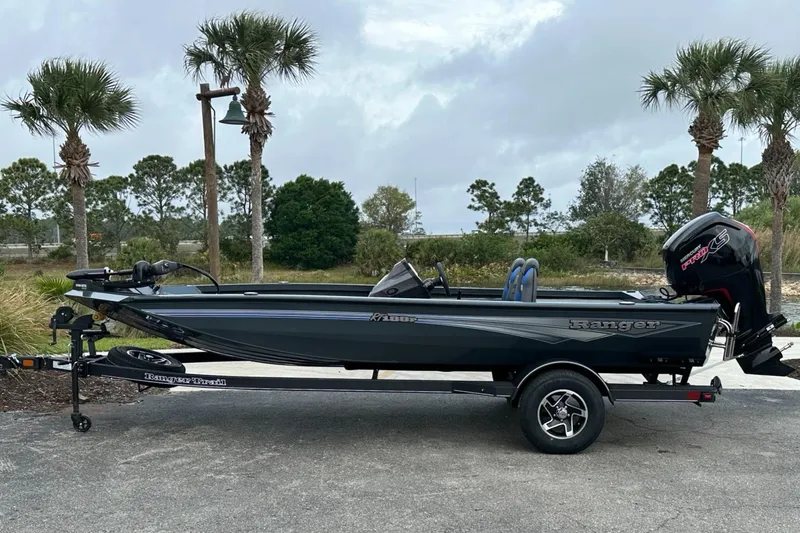 The Image of 2025 Ranger RT188P boat on trailer, parked outdoors with palm trees in background. - 0