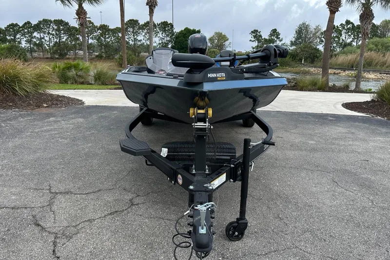 Slide: The Image of 2025 Ranger RT188P boat on trailer, parked outdoors with trees in background. - 3