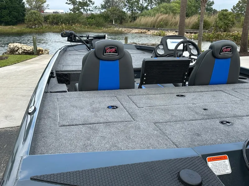 Slide: The Image of 2025 Ranger RT188P boat interior with blue seats, steering wheel, and lake view. - 6