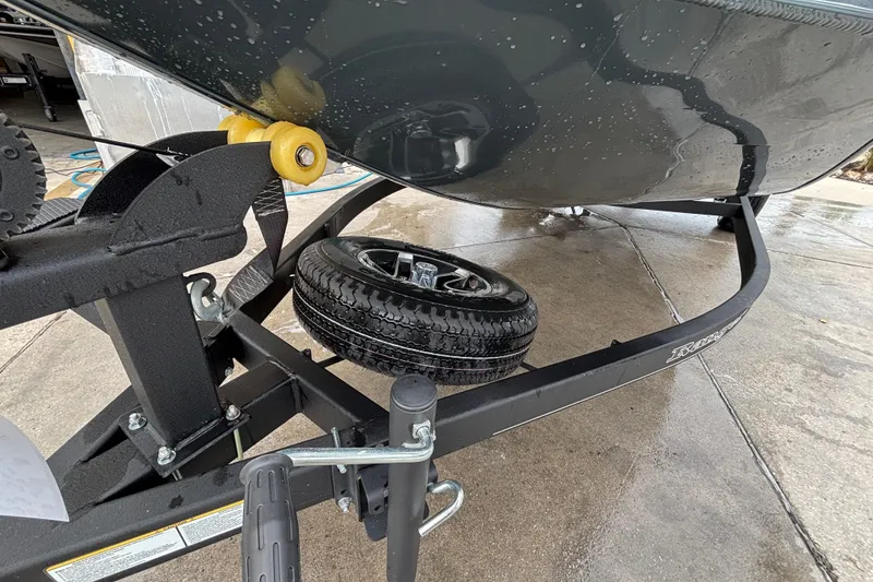 Slide: The Image of 2025 Ranger RT188P boat trailer with spare tire on wet concrete surface. - 86