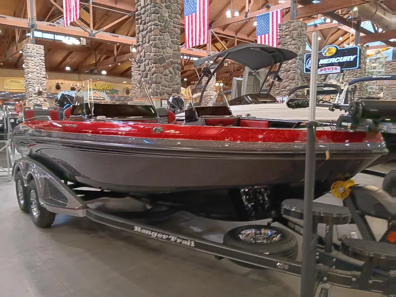 The Image of 2025 Ranger 1880MS boat displayed indoors with American flags in the background. - 0