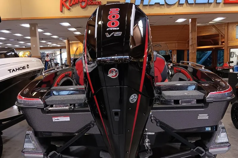 Slide: The Image of Ranger 1880MS 2025 boat with powerful 200 V6 engine displayed indoors. - 2