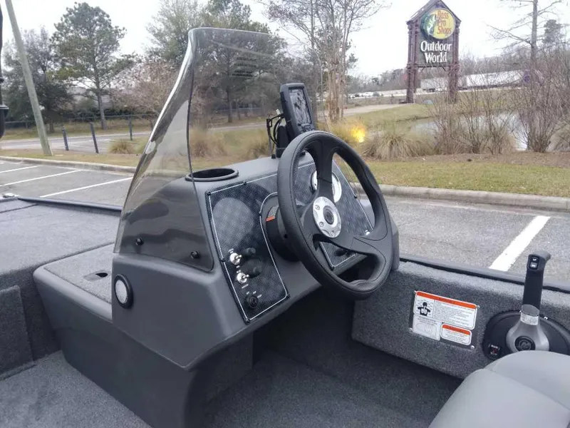 Slide: The Image of 2025 Tracker Bass Tracker Classic XL boat dashboard with steering wheel and controls. - 10