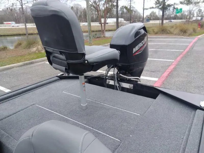 Slide: The Image of 2025 Tracker Bass Tracker Classic XL boat with Mercury motor in a parking lot. - 11