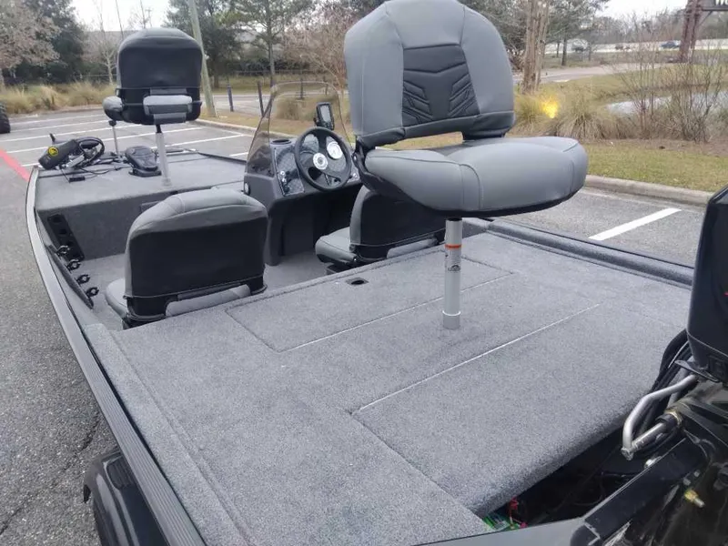 Slide: The Image of 2025 Tracker Bass Tracker Classic XL boat with gray seating and spacious deck. - 12