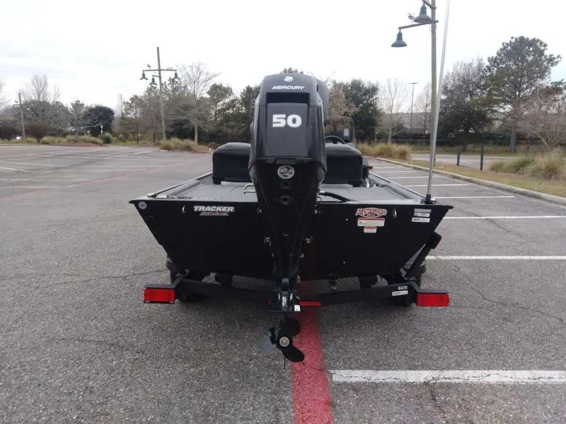 Slide: The Image of 2025 Tracker Bass Tracker Classic XL boat with Mercury 50 engine in parking lot. - 2