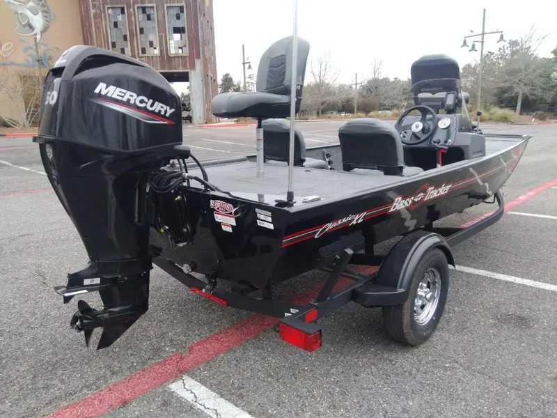 Slide: The Image of 2025 Tracker Bass Tracker Classic XL boat with Mercury engine in parking lot. - 3