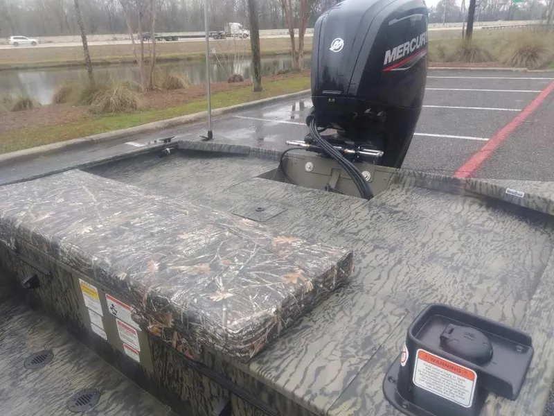 Slide: The Image of 2025 Tracker Grizzly 1860 CC boat with camo design and Mercury outboard motor. - 11
