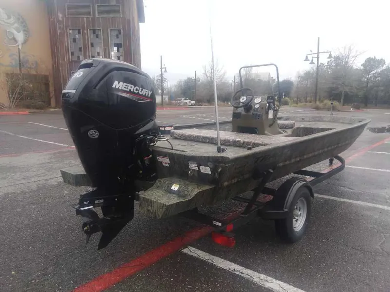 Slide: The Image of 2025 Tracker Grizzly 1860 CC boat with Mercury engine on trailer in parking lot. - 3