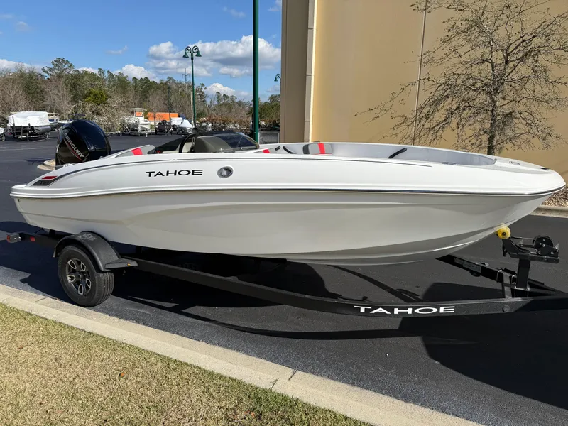 Slide: The Image of 2025 Tahoe T18 boat on trailer, parked outdoors, side view. - 4