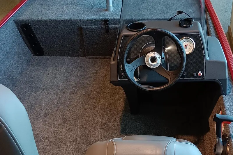 Slide: The Image of 2025 Tracker Bass Tracker Classic XL boat interior with steering wheel and dashboard. - 3