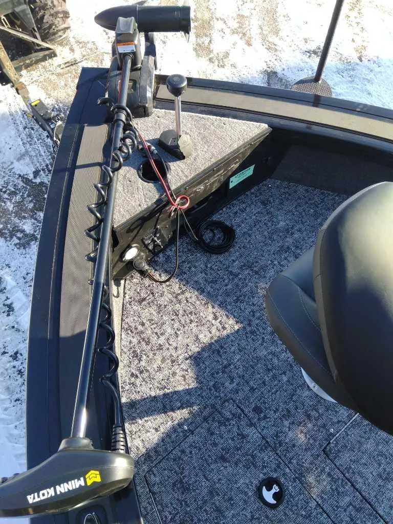 Slide: The Image of 2025 Tracker Targa V-18 WT boat interior with Minn Kota trolling motor. - 2