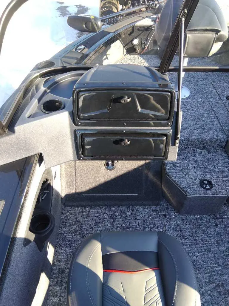 Slide: The Image of 2025 Tracker Targa V-18 WT boat interior with storage compartments and seating. - 4