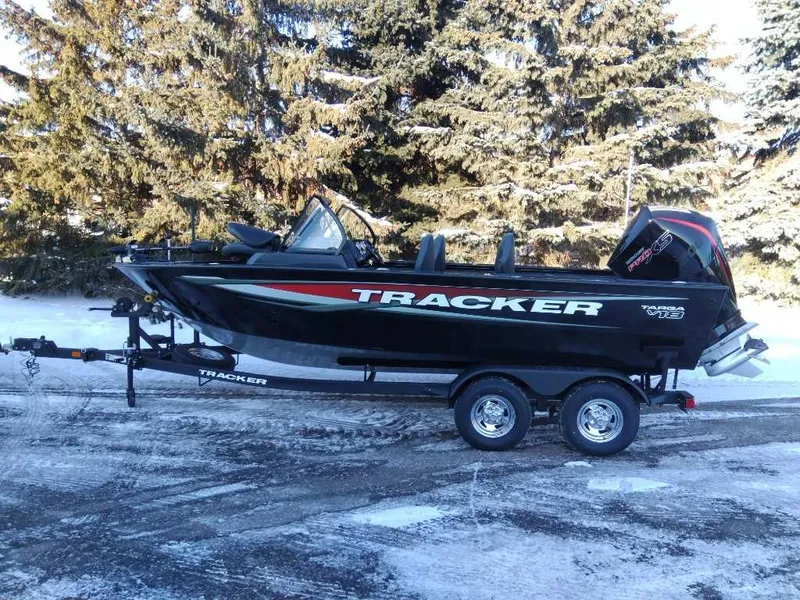 Slide: The Image of 2025 Tracker Targa V-18 WT boat on trailer, parked on snowy ground. - 7