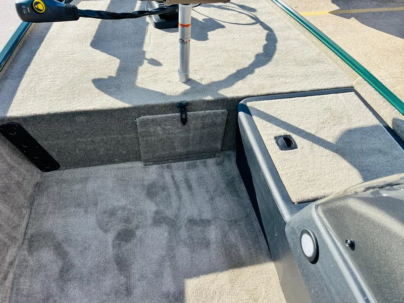Slide: The Image of 2025 Tracker Bass Tracker Classic Limited boat interior with carpeted deck and storage compartments. - 14