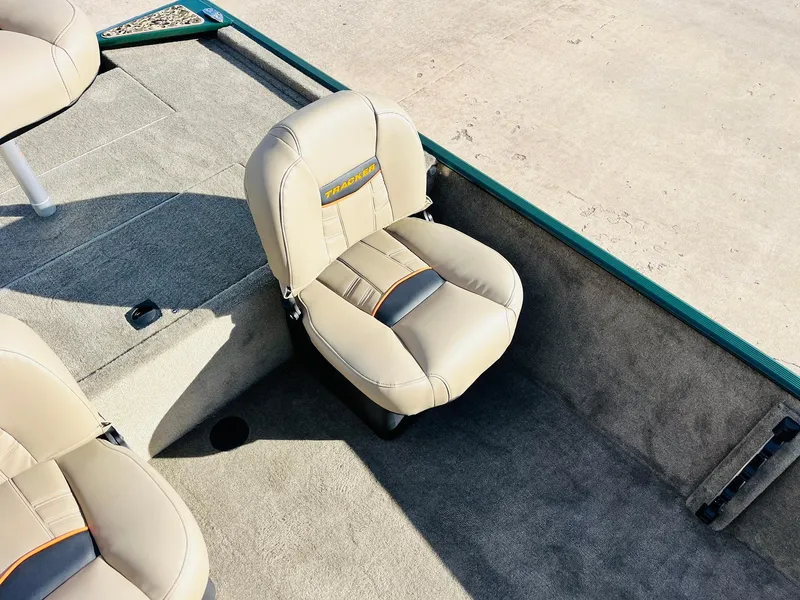 Slide: The Image of 2025 Tracker Bass Tracker Classic Limited boat seat, beige upholstery, spacious deck area. - 18
