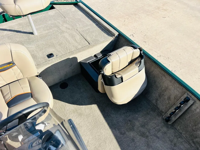 Slide: The Image of 2025 Tracker Bass Tracker Classic Limited boat interior with beige seating and carpeted flooring. - 19