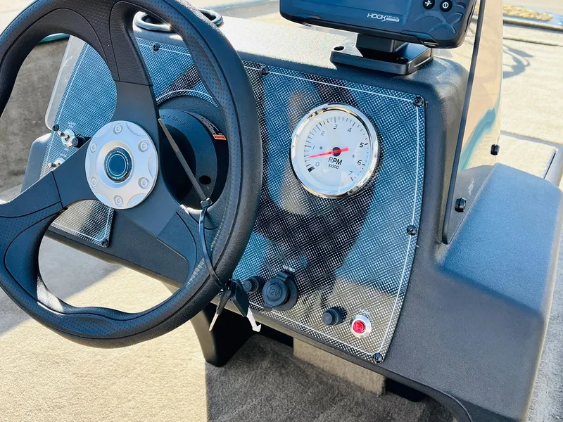 Slide: The Image of 2025 Tracker Bass Tracker Classic Limited dashboard with steering wheel and gauge. - 27