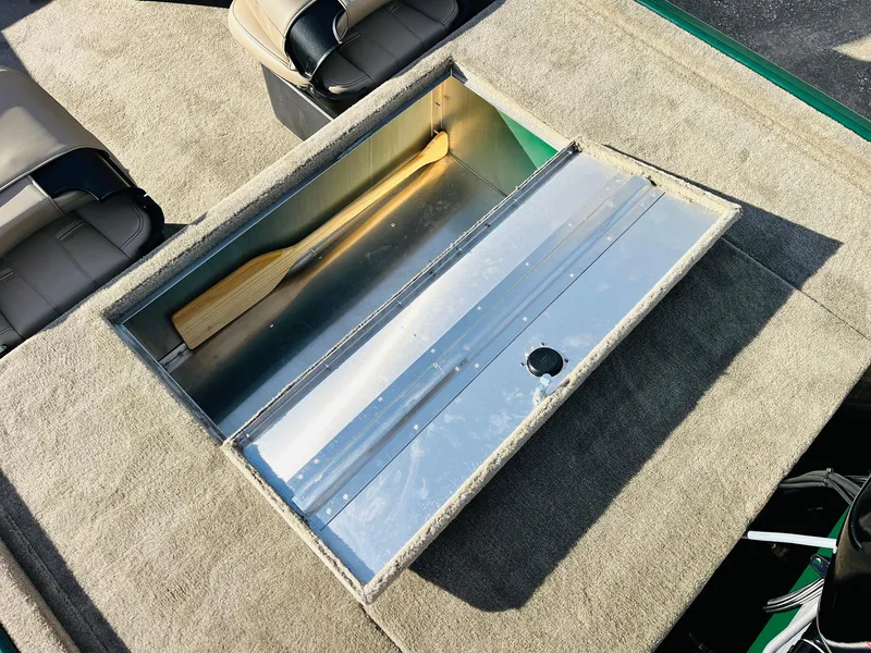 Slide: The Image of 2025 Tracker Bass Tracker Classic Limited boat storage compartment with paddle. - 35