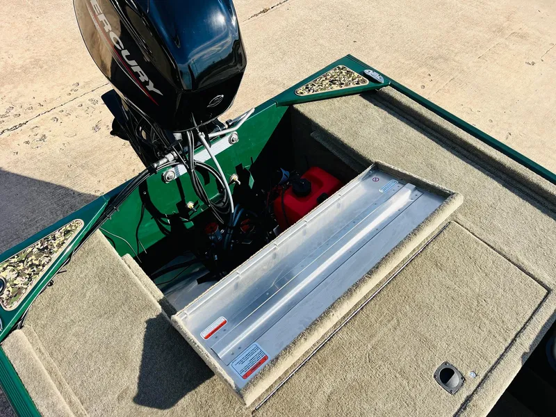 Slide: The Image of 2025 Tracker Bass Tracker Classic Limited boat with Mercury engine and open storage compartment. - 36