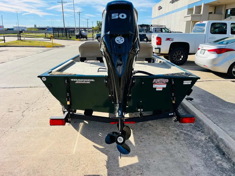 Slide: The Image of 2025 Tracker Bass Tracker Classic Limited boat with 50 HP motor, parked outdoors. - 5
