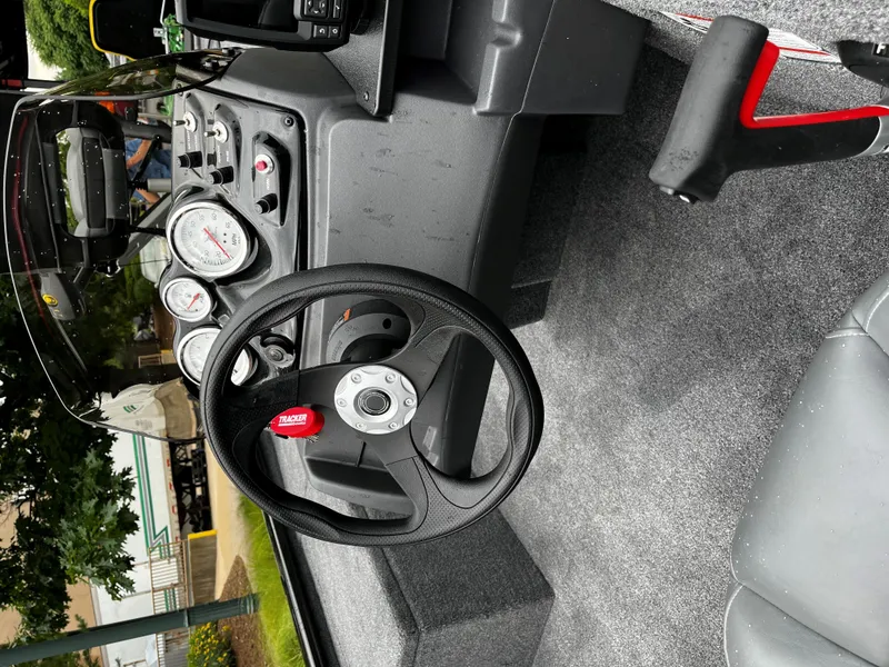 Slide: The Image of Interior of a 2025 Tracker Pro 170 boat, featuring steering wheel and dashboard controls. - 3