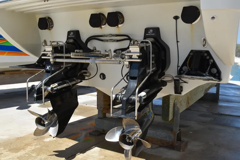 Slide: The Image of 2008 Formula 353 FASTech boat stern with dual propellers and outdrives on a dock. - 12