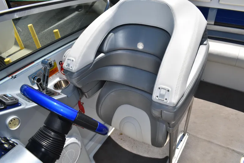 Slide: The Image of 2008 Formula 353 FASTech boat cockpit with blue steering wheel and cushioned seat. - 22
