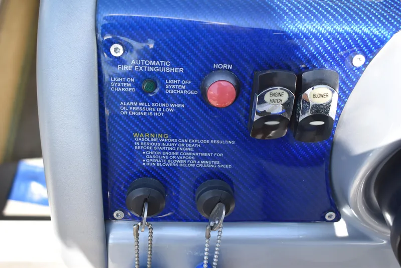 Slide: The Image of Control panel of a 2008 Formula 353 FASTech boat with fire extinguisher and engine switches. - 28