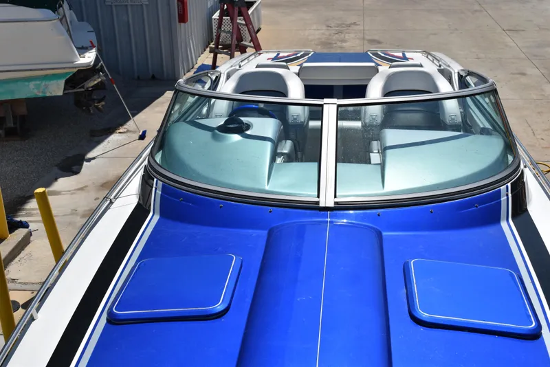 Slide: The Image of 2008 Formula 353 FASTech boat with blue deck and dual seats, docked outdoors. - 41
