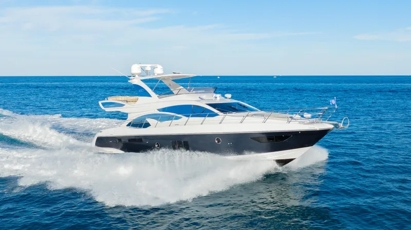 The Image of Azimut 60 Flybridge 2017 yacht cruising on open sea under clear blue sky. - 1