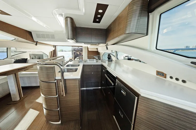 Slide: The Image of Luxurious interior of 2017 Azimut 60 Flybridge yacht with modern kitchen and seating area. - 12