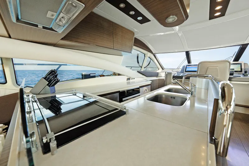 Slide: The Image of Luxurious interior of 2017 Azimut 60 Flybridge yacht with modern kitchen amenities. - 13