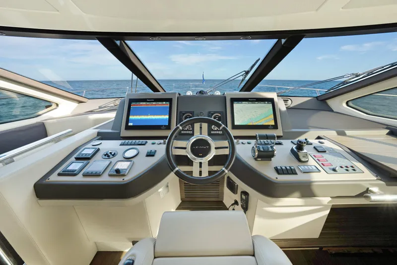 Slide: The Image of Cockpit of 2017 Azimut 60 Flybridge yacht with modern navigation controls and ocean view. - 17