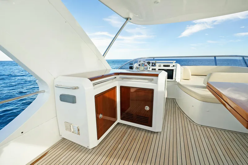 Slide: The Image of Azimut 60 Flybridge 2017 yacht interior with ocean view, featuring sleek design and wooden accents. - 34