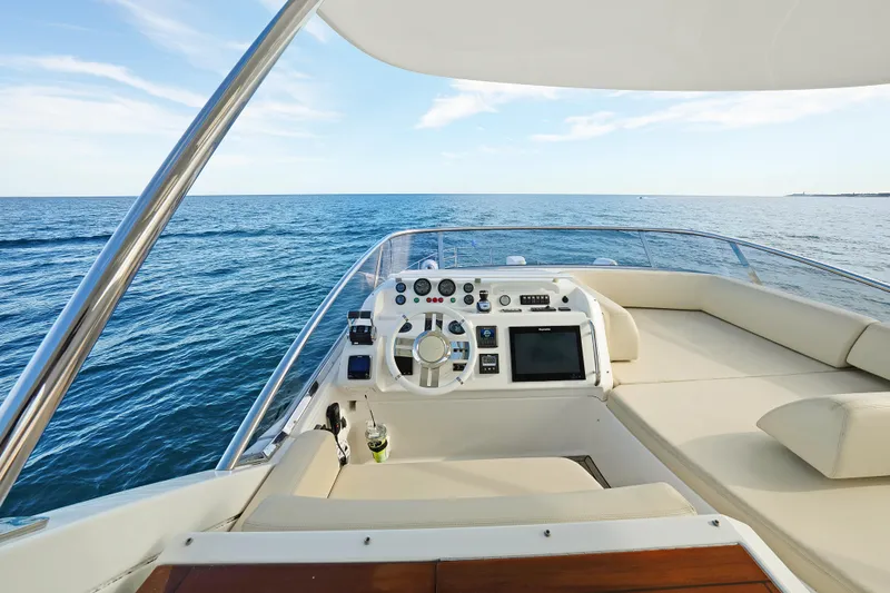 Slide: The Image of 2017 Azimut 60 Flybridge yacht helm with ocean view and modern controls. - 36