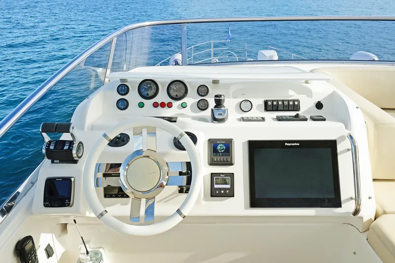 Slide: The Image of Helm of 2017 Azimut 60 Flybridge yacht with modern navigation controls and steering wheel. - 37