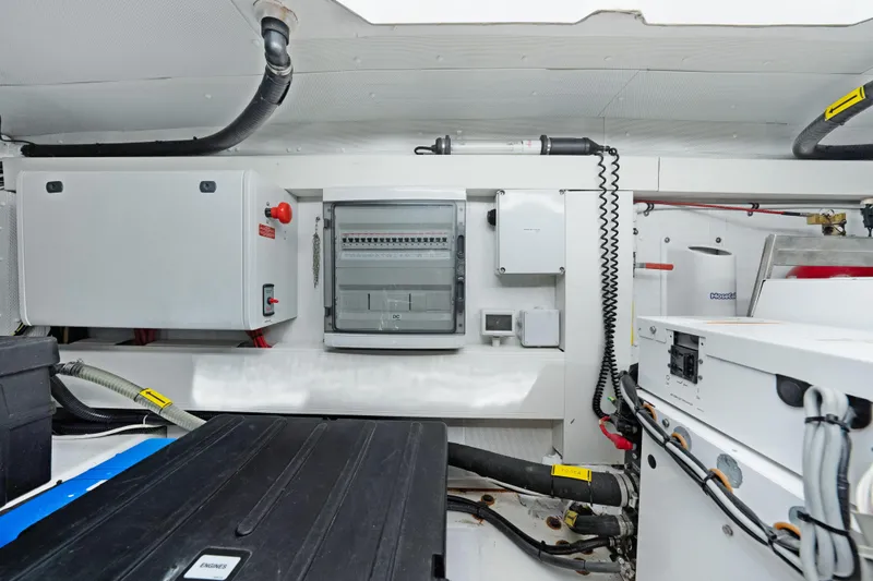 Slide: The Image of Engine room of a 2017 Azimut 60 Flybridge yacht, showcasing electrical panels and equipment. - 43