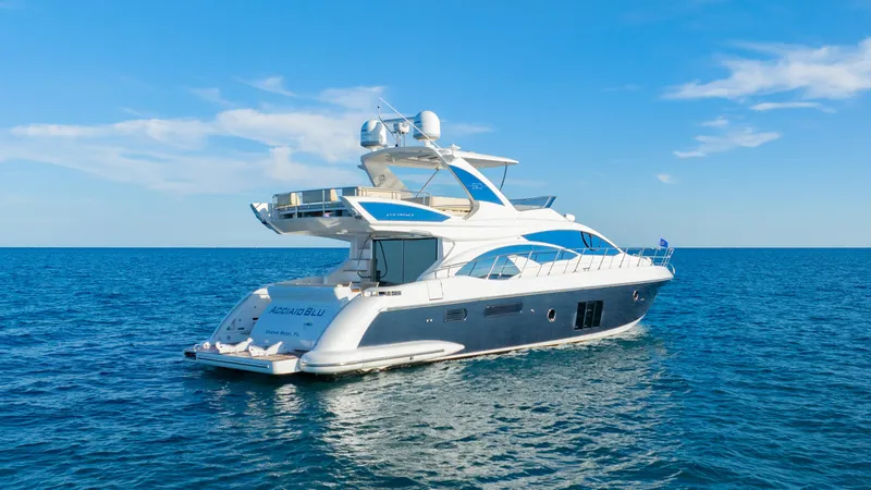 Slide: The Image of 2017 Azimut 60 Flybridge yacht cruising on open sea under clear blue sky. - 48