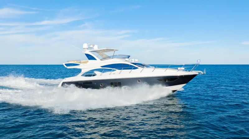Slide: The Image of Azimut 60 Flybridge 2017 yacht cruising on open sea under clear blue sky. - 49