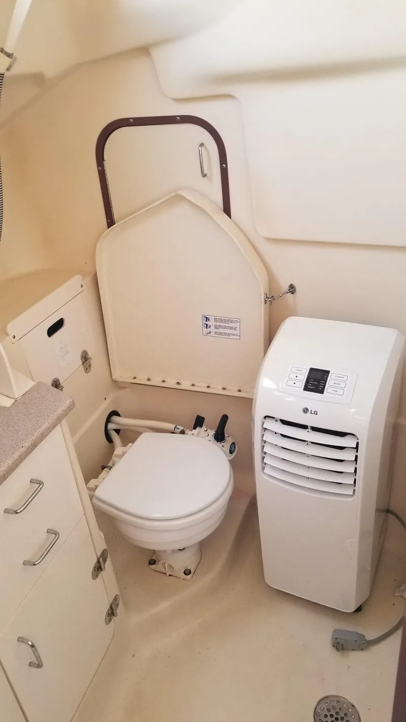 Slide: The Image of 1999 Hunter 340 yacht bathroom with toilet and portable air conditioner. - 11