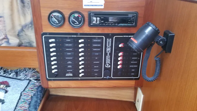 Slide: The Image of Control panel of a 1999 Hunter 340 sailboat with gauges and switches. - 14