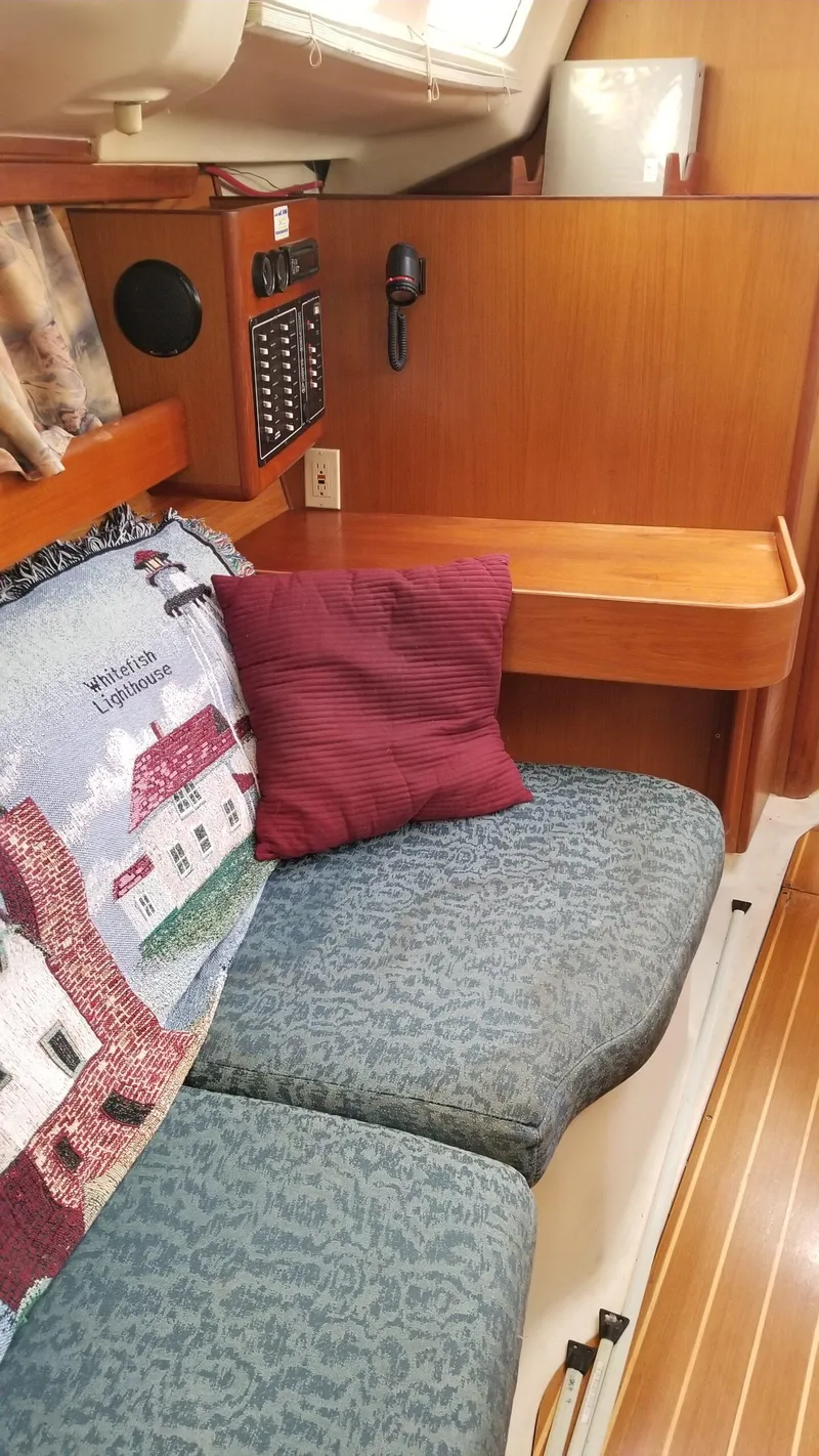 Slide: The Image of Interior of 1999 Hunter 340 sailboat with cozy seating and nautical decor. - 15