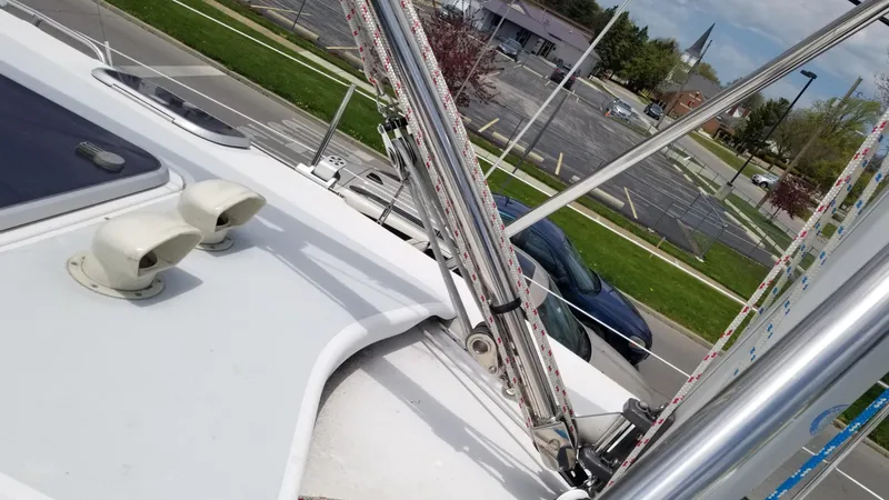 Slide: The Image of Deck view of a 1999 Hunter 340 sailboat with rigging and parked cars in the background. - 2