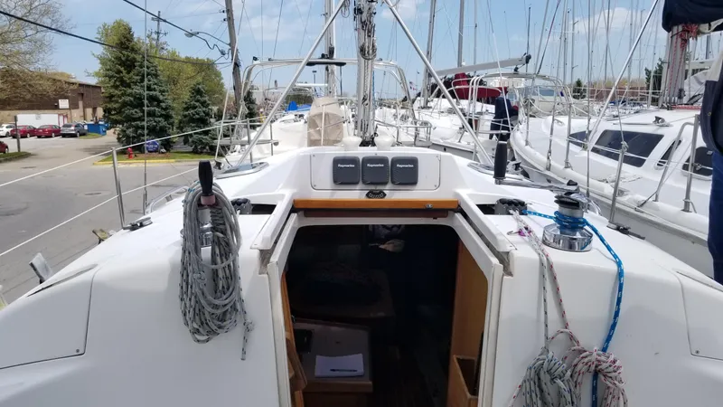 Slide: The Image of Hunter 340 sailboat cockpit view, 1999 model, docked with ropes and equipment visible. - 3